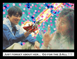 A man and a woman on a teal background with many magenta and bright blue danmaku bullets scattered around. The man is sitting down holding a red and white jet ship from the arcade shoot-em-up DoDonPachi which is shooting a bright yellow laser. The girl is fading out. There is text at the bottom that reads "Just forget about her... Go for the 2-All!"